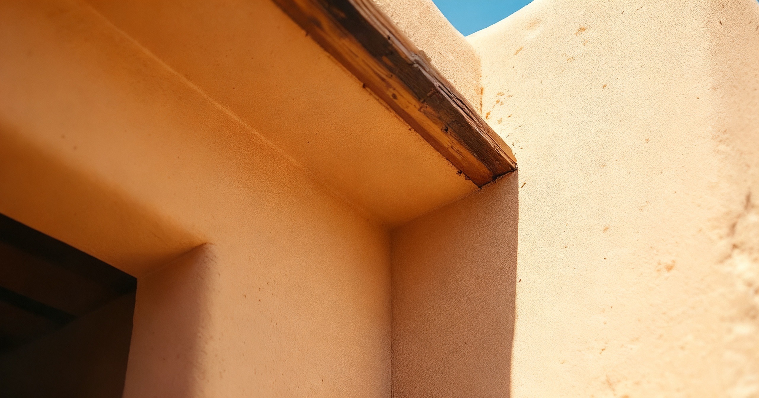 Illustrative example: the same home&rsquo;s stucco eave corner clean and clear of wasp nests after treatment